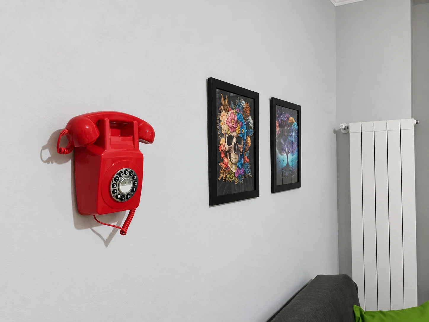 Telefono rosso d’epoca e quadri alla parete